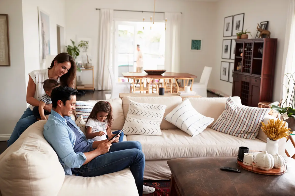 A family reading together on a sofa in a living room